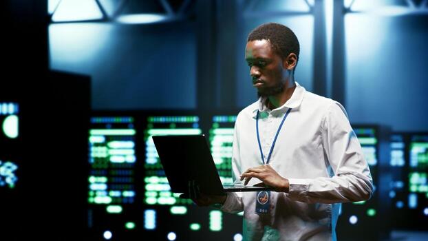 Admin using laptop to set up supercomputer hub infrastructure advanced firewalls and intrusion detection systems. Cybersecurity professional preventing hacking, malware, and phishing attacks photo