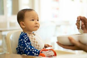 Babies are eating food in 6 month year olds photo