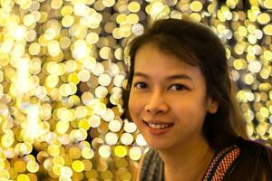 Young asian woman on bokeh lights background photo