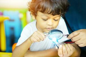 3 year old children in Asia are conducting scientific experiments. photo