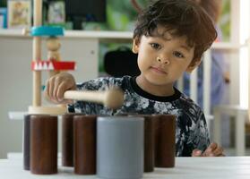 Asian little boy playing with wood toys photo