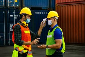 Worker check body temperature Before working in the warehouse photo