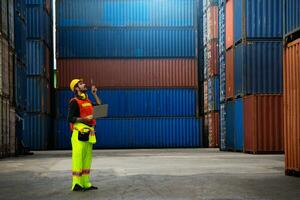 industrial worker is controlling container loading in import-export business. photo