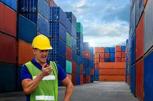 industrial worker is controlling container loading in import-export business. photo
