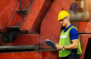 Men Industrial workers or engineers checking machine photo