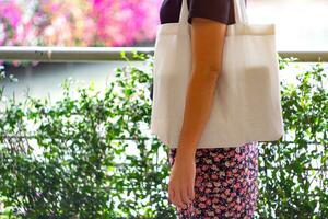 Focus of white cloth bags and Asian woman. photo