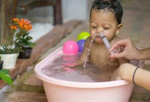 Asian baby saline nasal wash photo