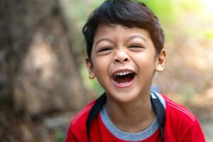 Boy wearing a red shirt laughed happily photo