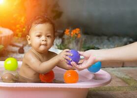 Asian baby Bathing in tubs photo