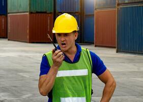 industrial worker is controlling container loading in import-export business. photo