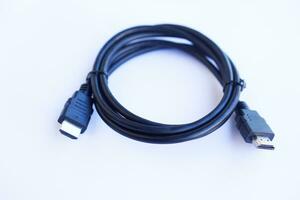 Black HDMI connector cable on white background. Equipment for transmitting digital video and audio from computer to a  monitor,  projector or TV screen. Concept, technology electronic device photo