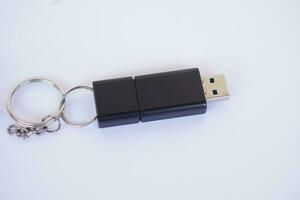 USB memory stick with information storage, on white background. Small, portable device that plugs into USB port on computer to data backup, storage or transfer files between devices. photo