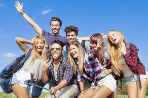 group of friends taking a self portrait with selfie stick photo