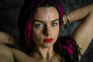 portrait of young beautiful woman is having fun with a red scarf photo