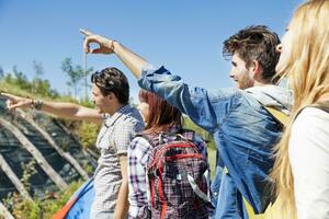 group of young hikers in the mountains preparing an excursion photo