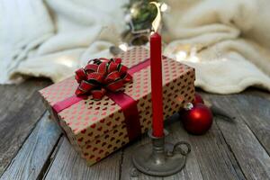 christmas decoration lights and red candle on wooden table photo