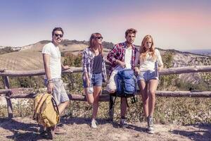 group of young hikers in the mountains preparing an excursion photo