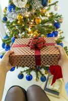 beautiful happy woman at home in the Christmas atmosphere among tree and gifts photo