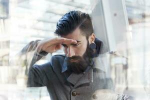 businessman looking through window photo