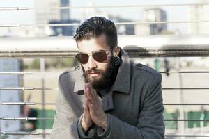 young hipster relaxes on an iron bridge photo