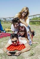 young boys and girls in campsite piled up smiling photo