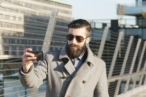 young hipsters businessman take selfie in a modern city photo