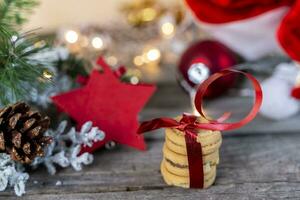 christmas decoration lights and three cookies on wooden table photo