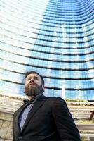 young businessman in a glass skyscraper photo