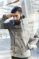 businessman looking through window photo