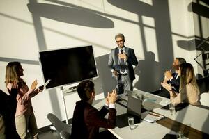 View at group of business people working together and preparing new project on a meeting in office photo