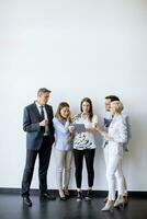 Business people standing by the wall in the office photo