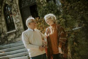 Senior couple embracing in autumn park photo