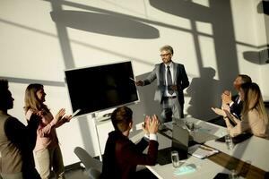 View at group of business people working together and preparing new project on a meeting in office photo