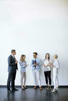 Business people standing by the wall in the office photo