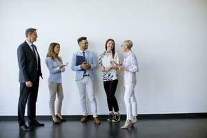 Business people standing by the wall in the office photo