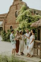 Group of young people cheering and having fun outdoors with drinks photo