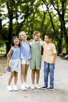 Group of asian and caucasian kids having fun in the park photo