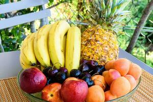 a bowl of fruit on a table photo