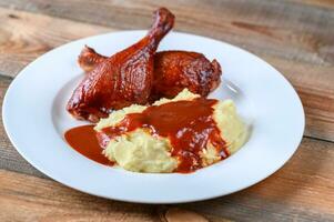 Barbecue duck legs with mashed potato photo
