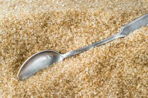 Spoon in brown sugar photo