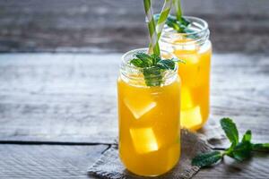 Glass jars of mango juice photo