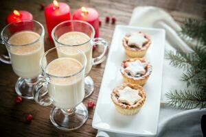 Glasses of eggnog with mince pies photo