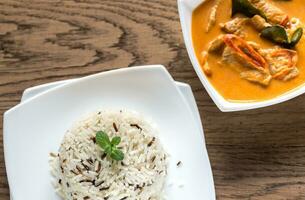 Thai panang curry with bowl of white and wild rice photo