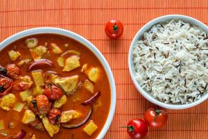 Thai yellow curry with chicken and rice photo