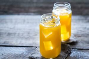 Glass jars of mango juice photo