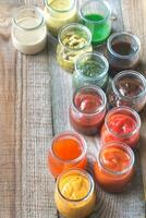 Assortment of sauces in the glass jars photo