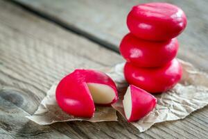 Stack of mini cheese on the wooden table photo