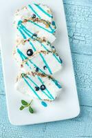 Sliced merengue roll with nuts photo