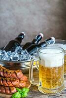 Grilled sausages  and mugs of beer photo