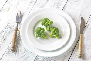 Fresh broccoli on the white plate photo